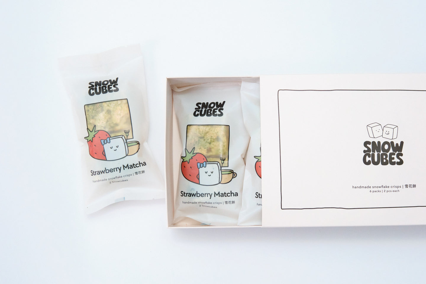 Strawberry Matcha Snowcubes — handmade Taiwanese snowflake crisps with freeze-dried strawberries and ceremonial-grade matcha, boxed with two pouches
