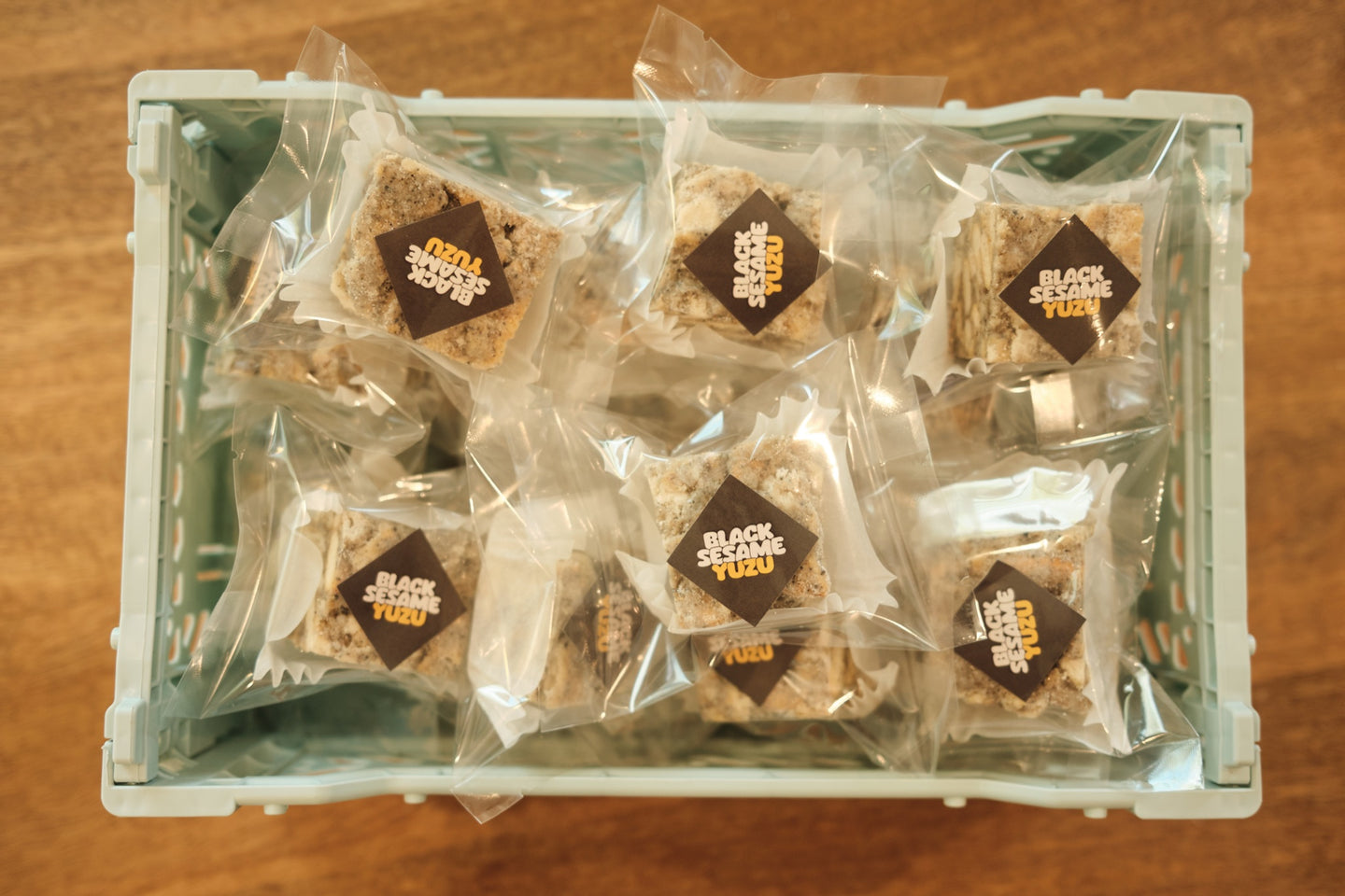 Black Sesame Yuzu Snowcubes — wrapped cubes in crate, wide