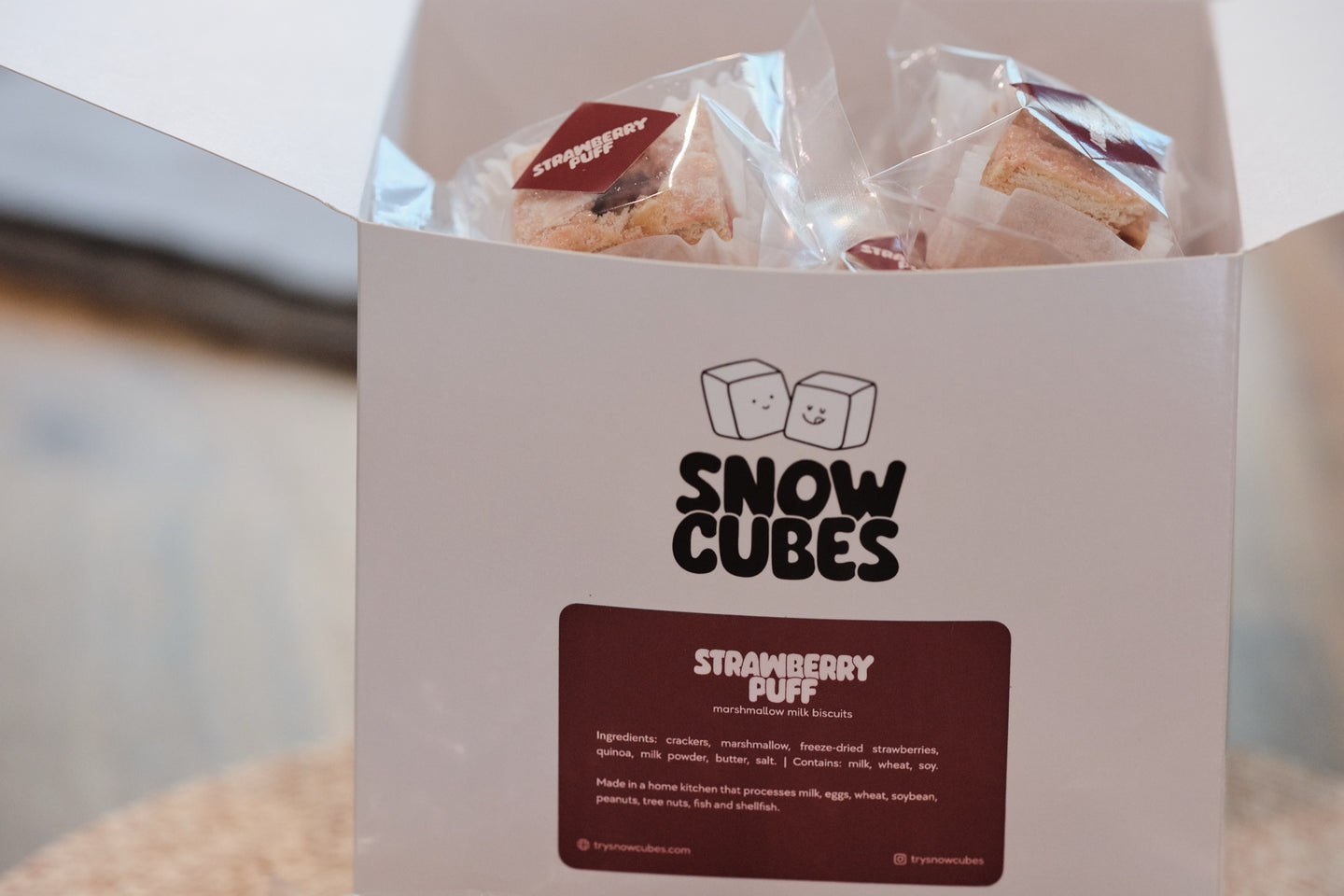 Strawberry Puff Snowcubes — wrapped pieces peeking out of the open box