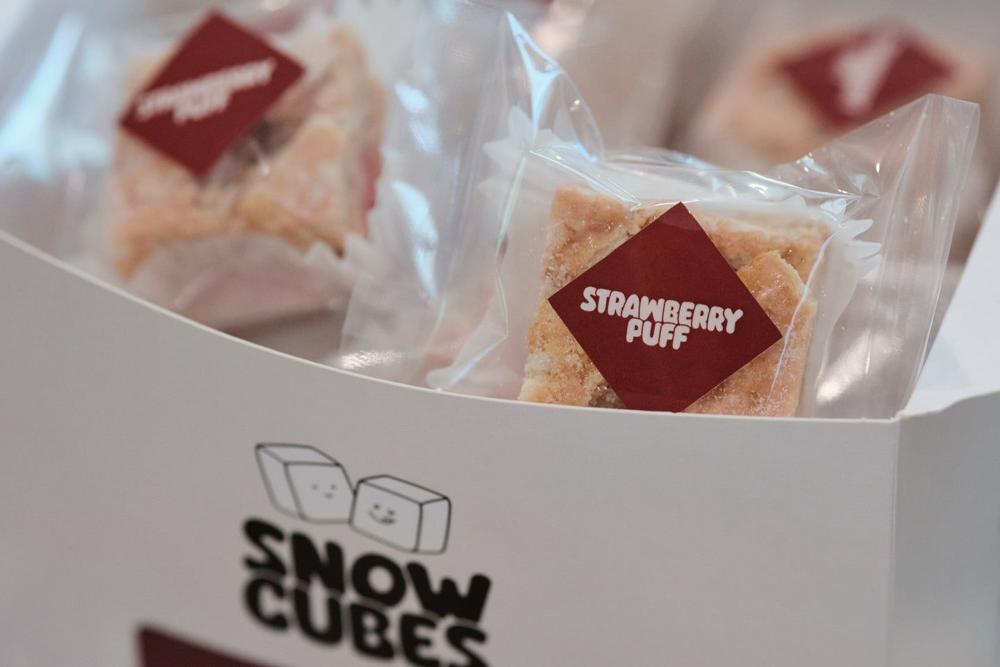 Strawberry Puff Snowcubes — close-up of an individually wrapped piece with its label