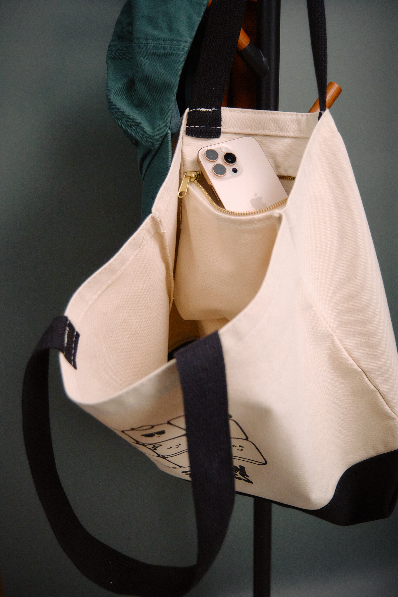 Nine's Company tote bag featuring the Snowcubes characters, with an inside brass zippered pocket